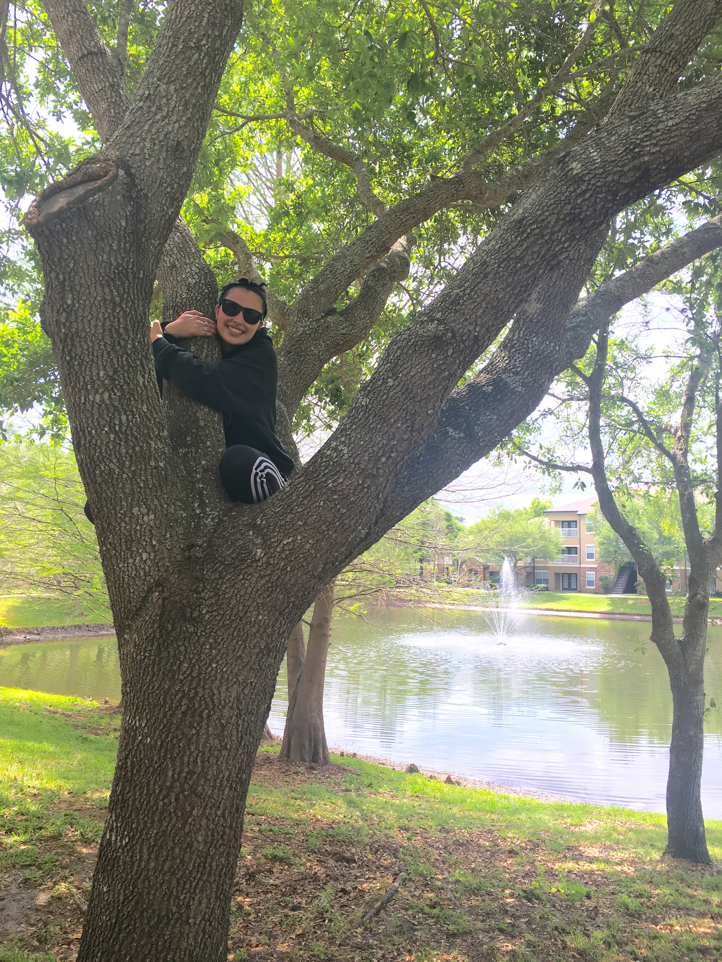 Picture of a girl hugging a tree.